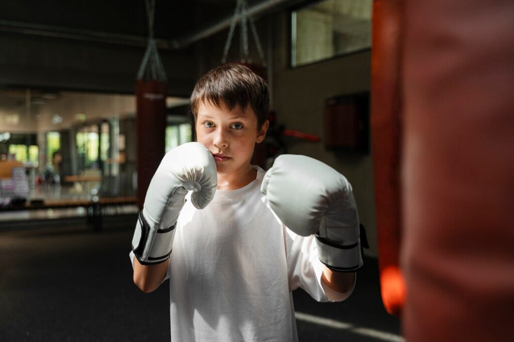 medium-shot-kid-practicing-boxing_23-2150930345